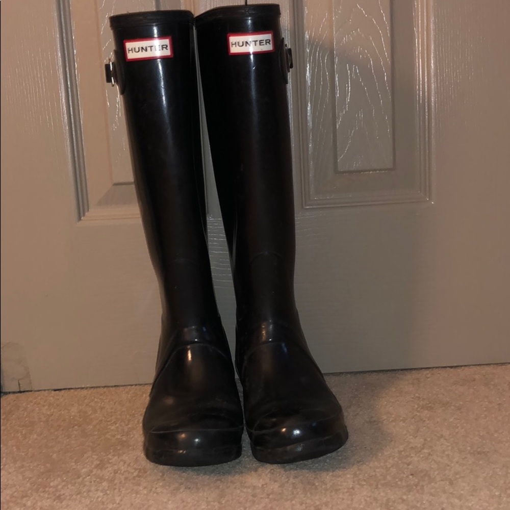 Tall glossy black Hunter rain boots